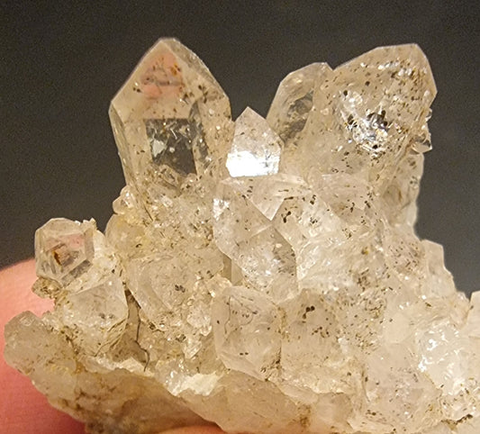 BERGKRYSTALL MED MØRKE MINERALINNESLUTNINGER